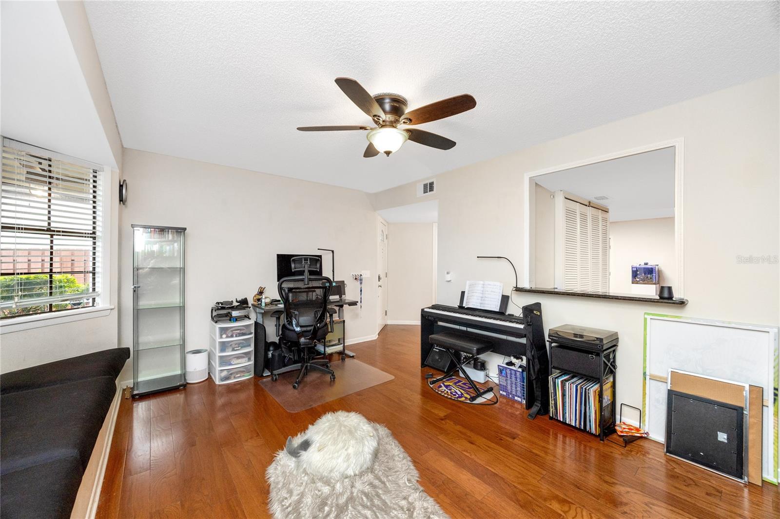 Pass through window into the kitchen provides flexibility of use for this space. How about a formal dining room to host the best parties?