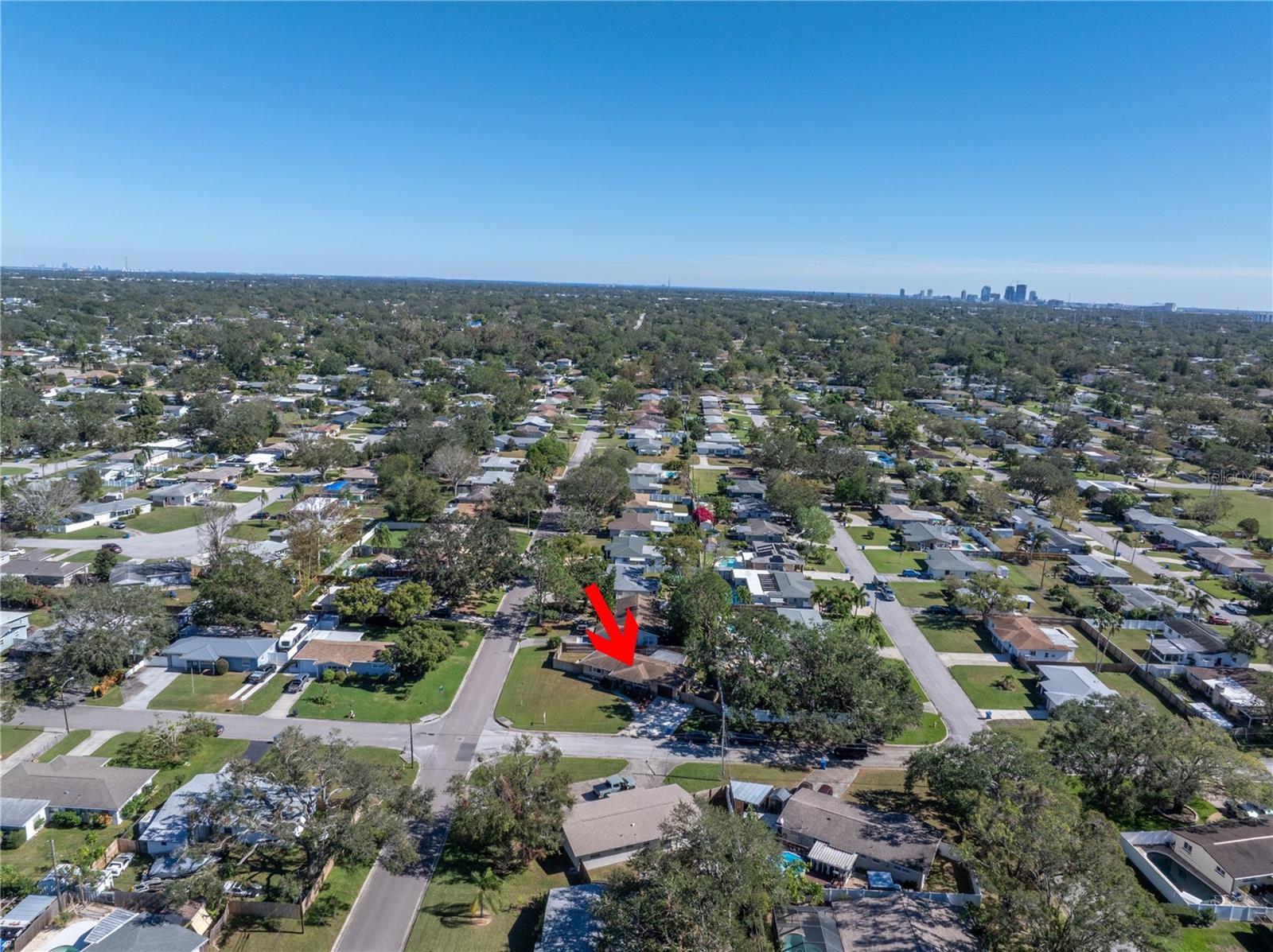 An aerial view highlights the well-maintained surrounding homes