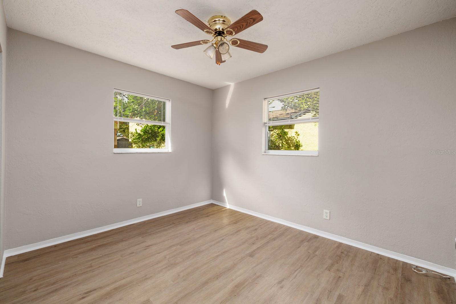 The second bedroom is a corner room at the back of the house. It has a windows that let in lots of natural light.