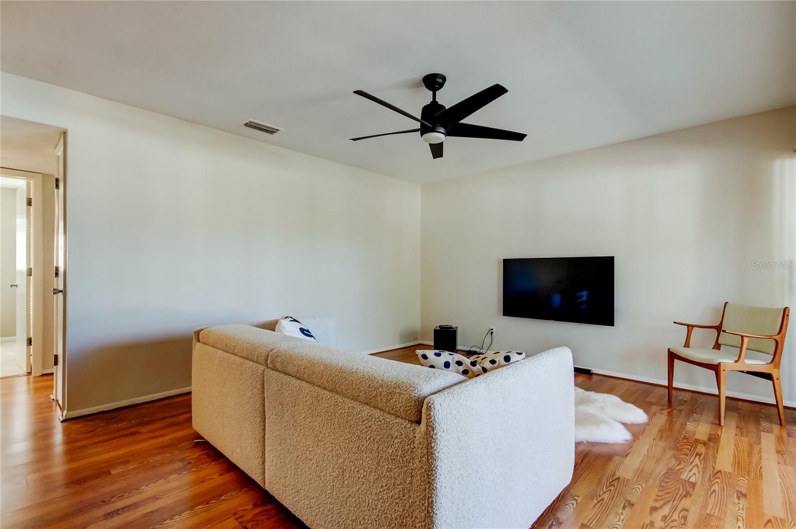 6. Living Room has Wood Laminate Flooring, Brand New Modern Ceiling Fan, Offers Variety of Furniture Layout Options!