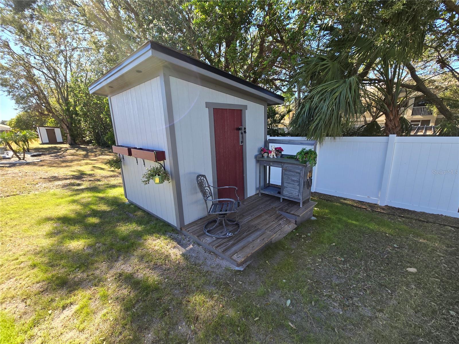 Shed for lawn tools, plant potting, and more.