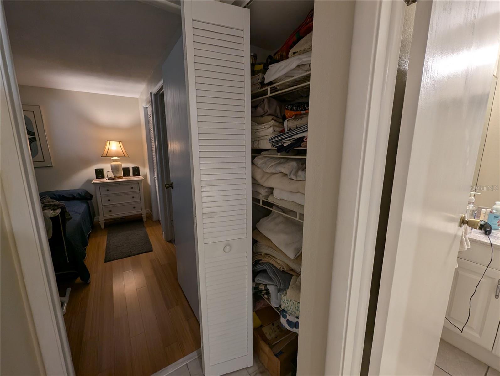 Linen closet before entering primary bedroom