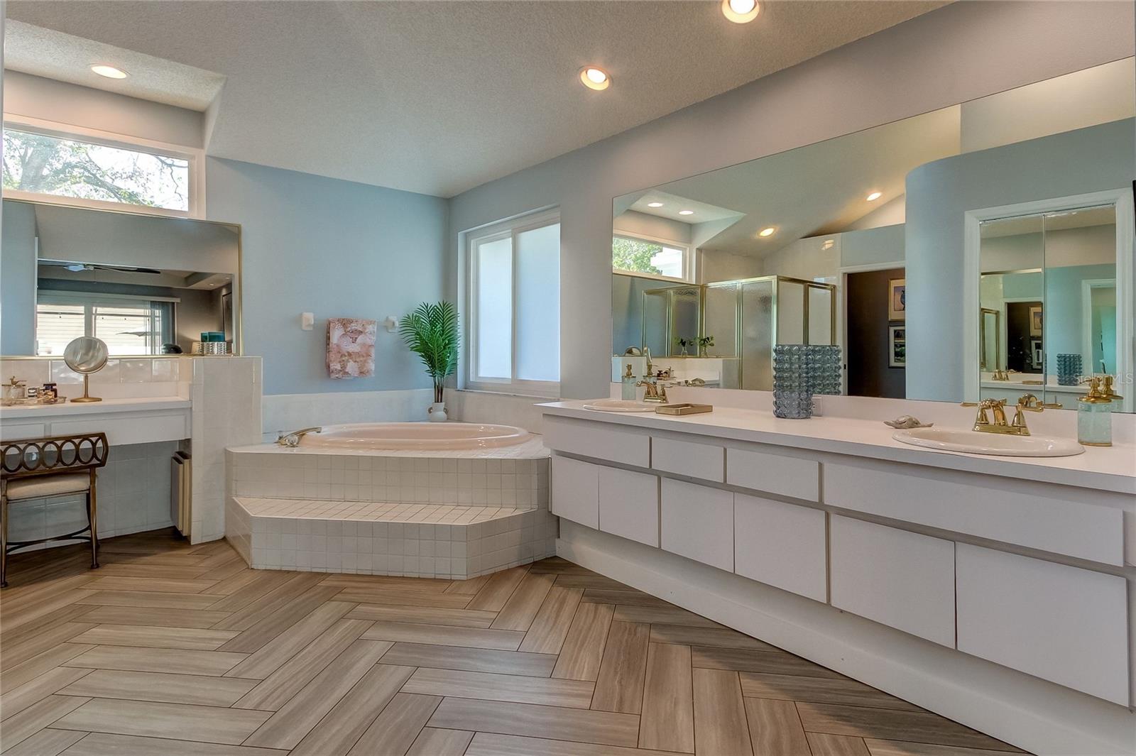 primary bath with garden tub and dual sinks