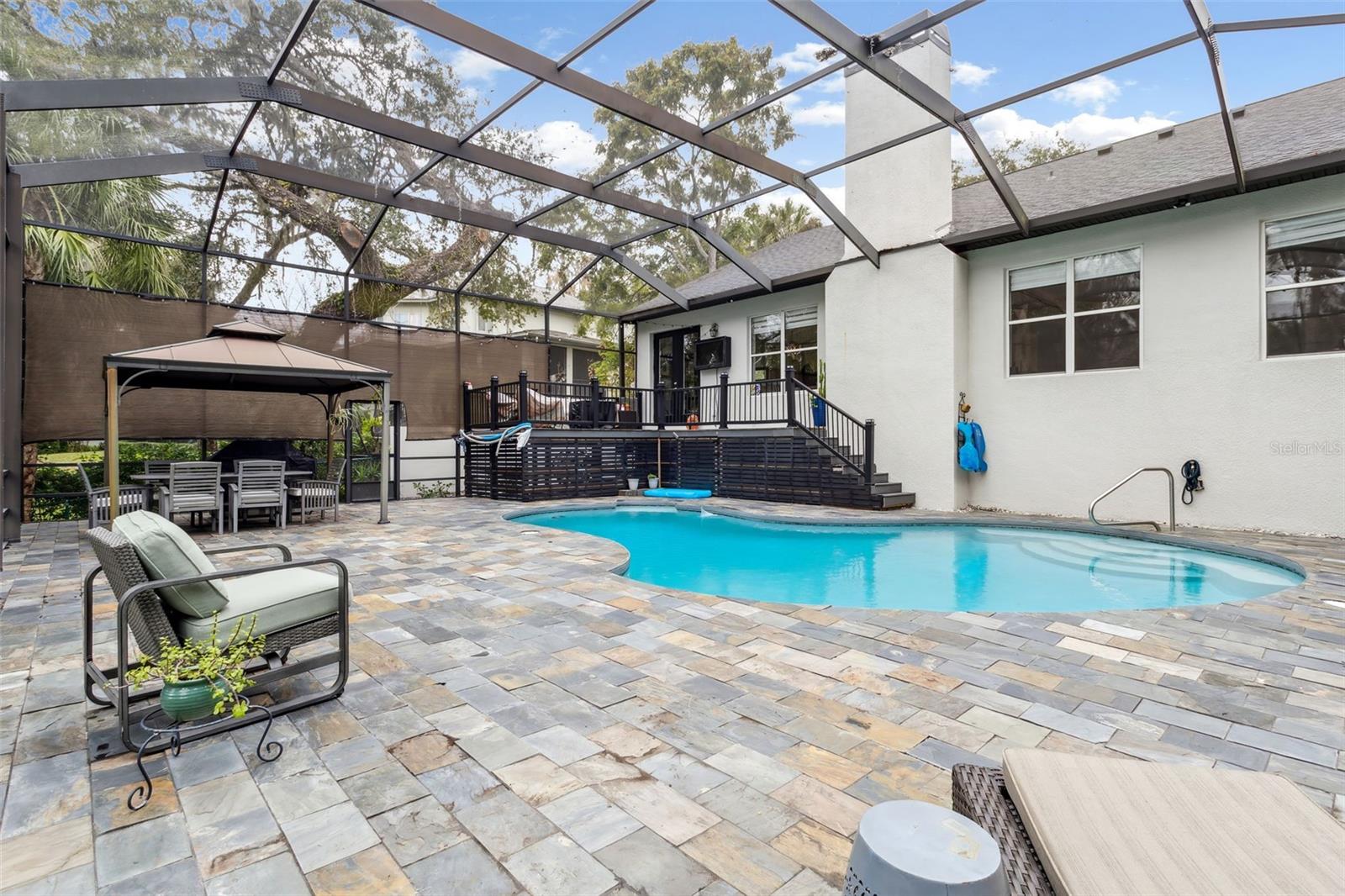 Large screened-in pool, and lush, serene surroundings ideal for relaxing or entertaining!