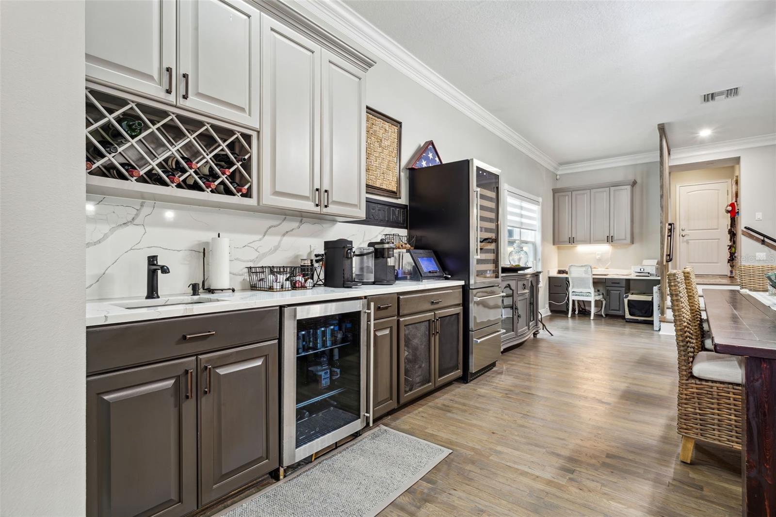 Upgraded stainless appliances, and a dining room featuring a wet bar complete with a beverage fridge and ice maker!