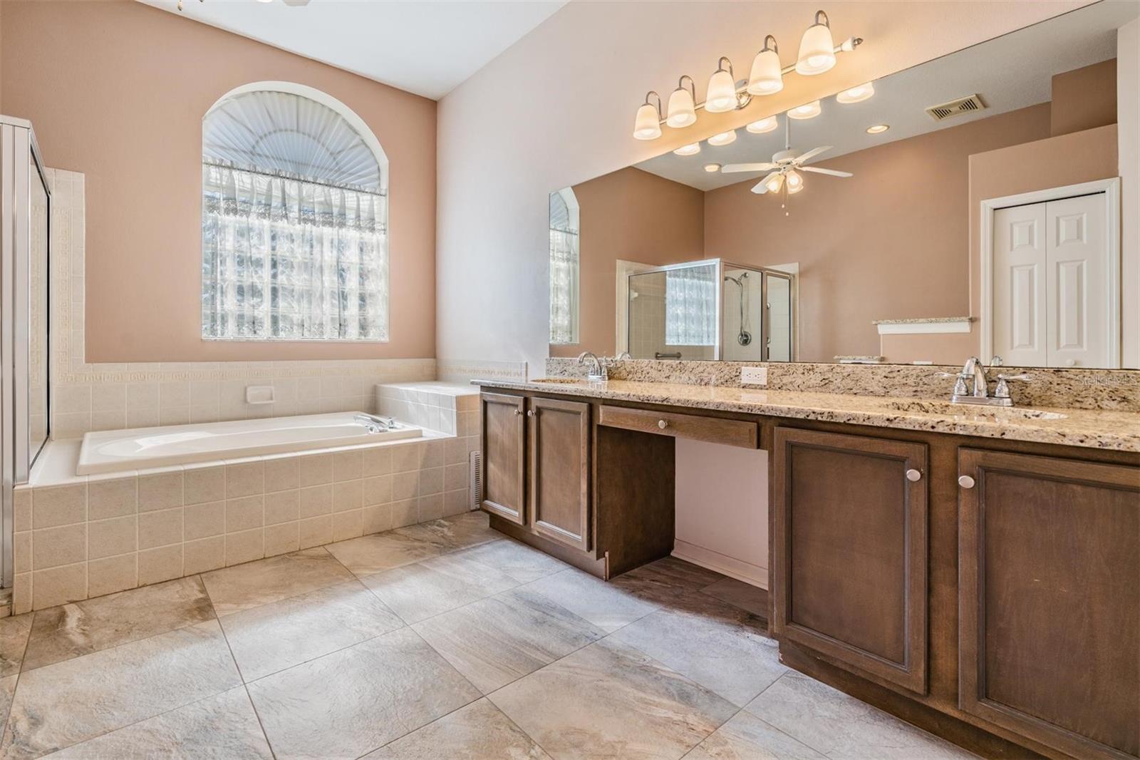 Master bath with tub for soaking and vanity for additional storage