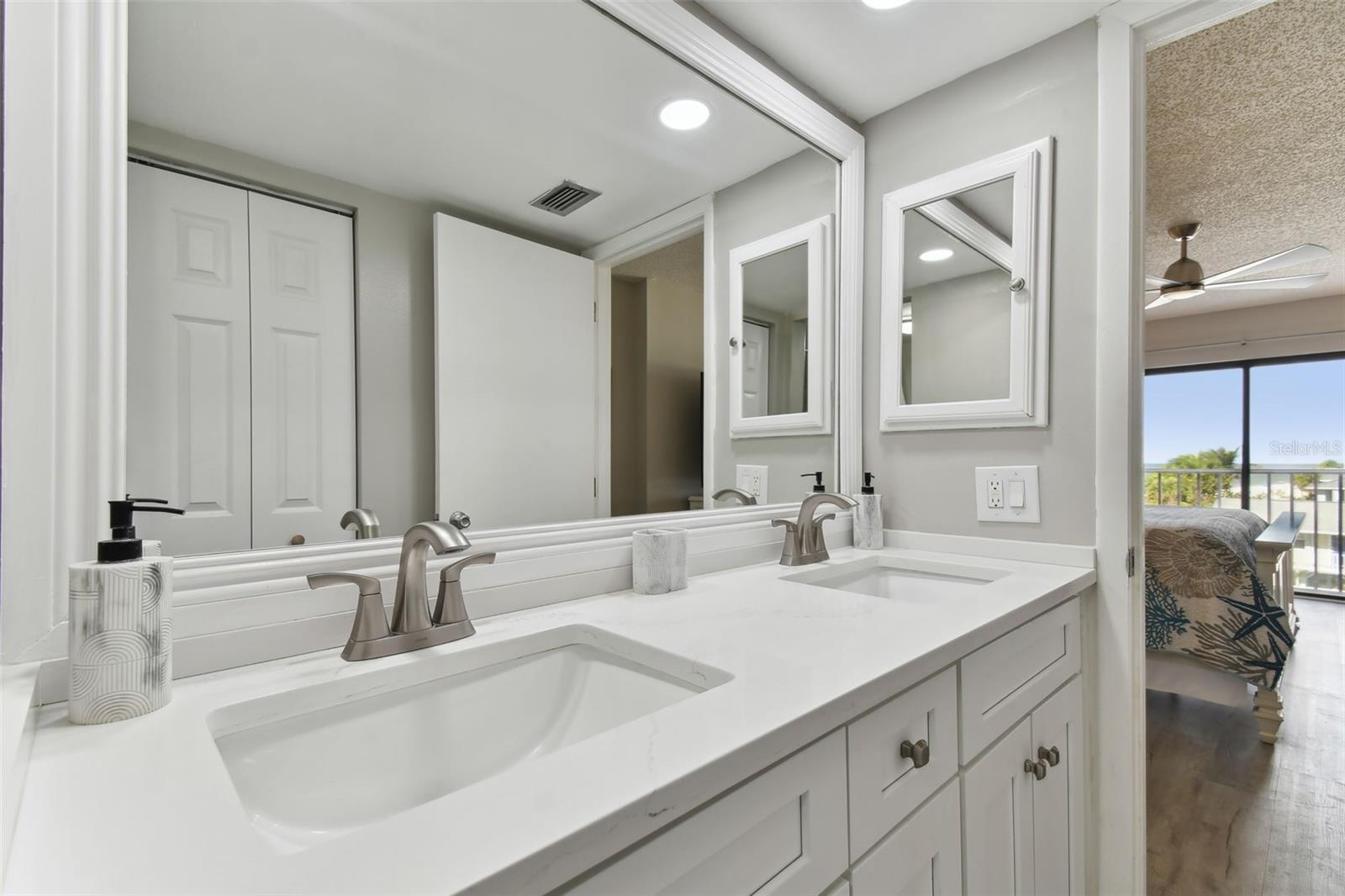 Gorgeous dual vanity with quartz countertops and shaker cabinetry