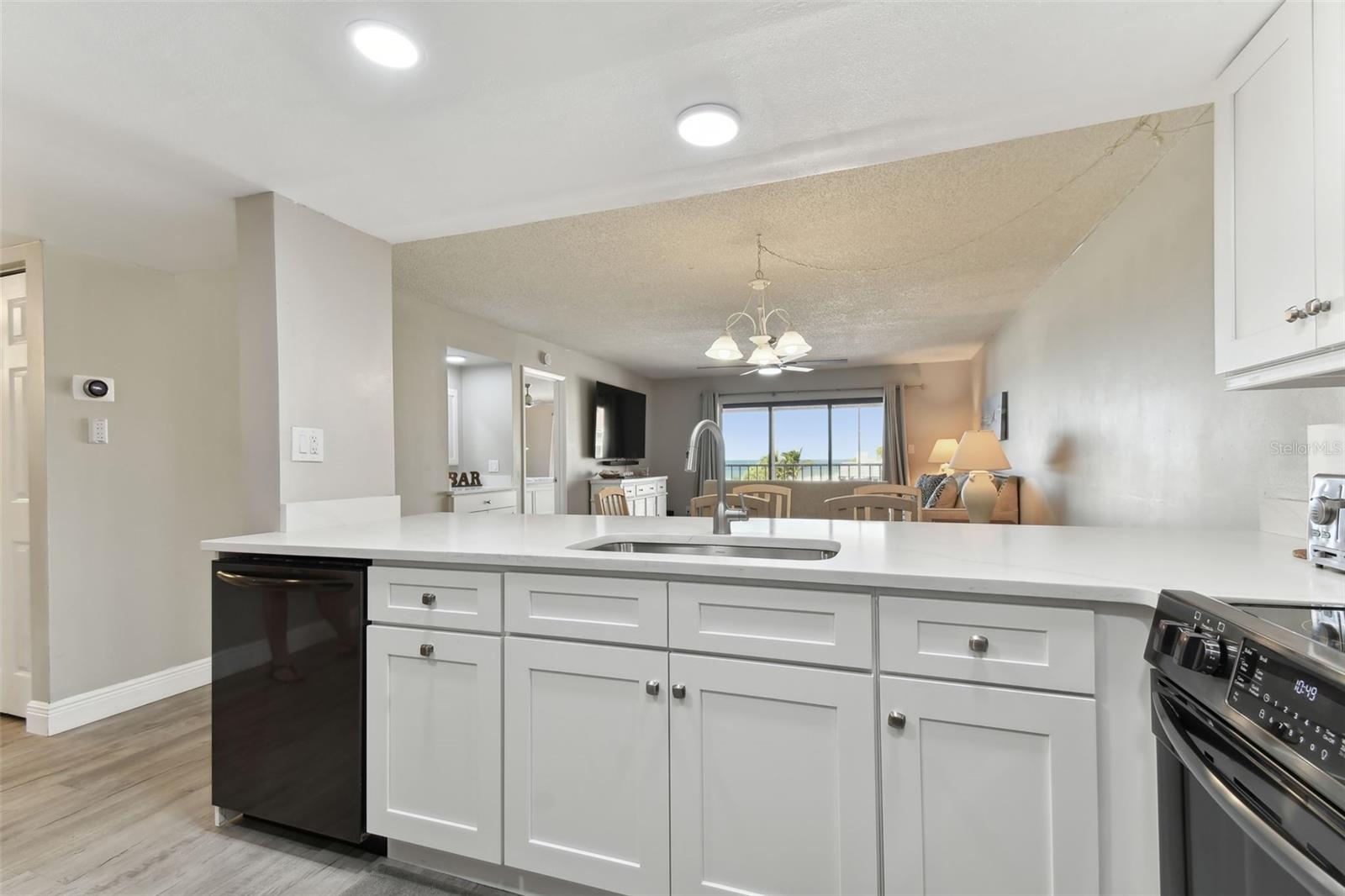 Gorgeous quartz countertops and white shaker style cabinetry