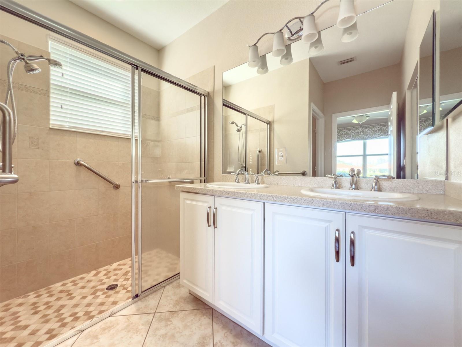 Walk-in framed glass shower and double vanity