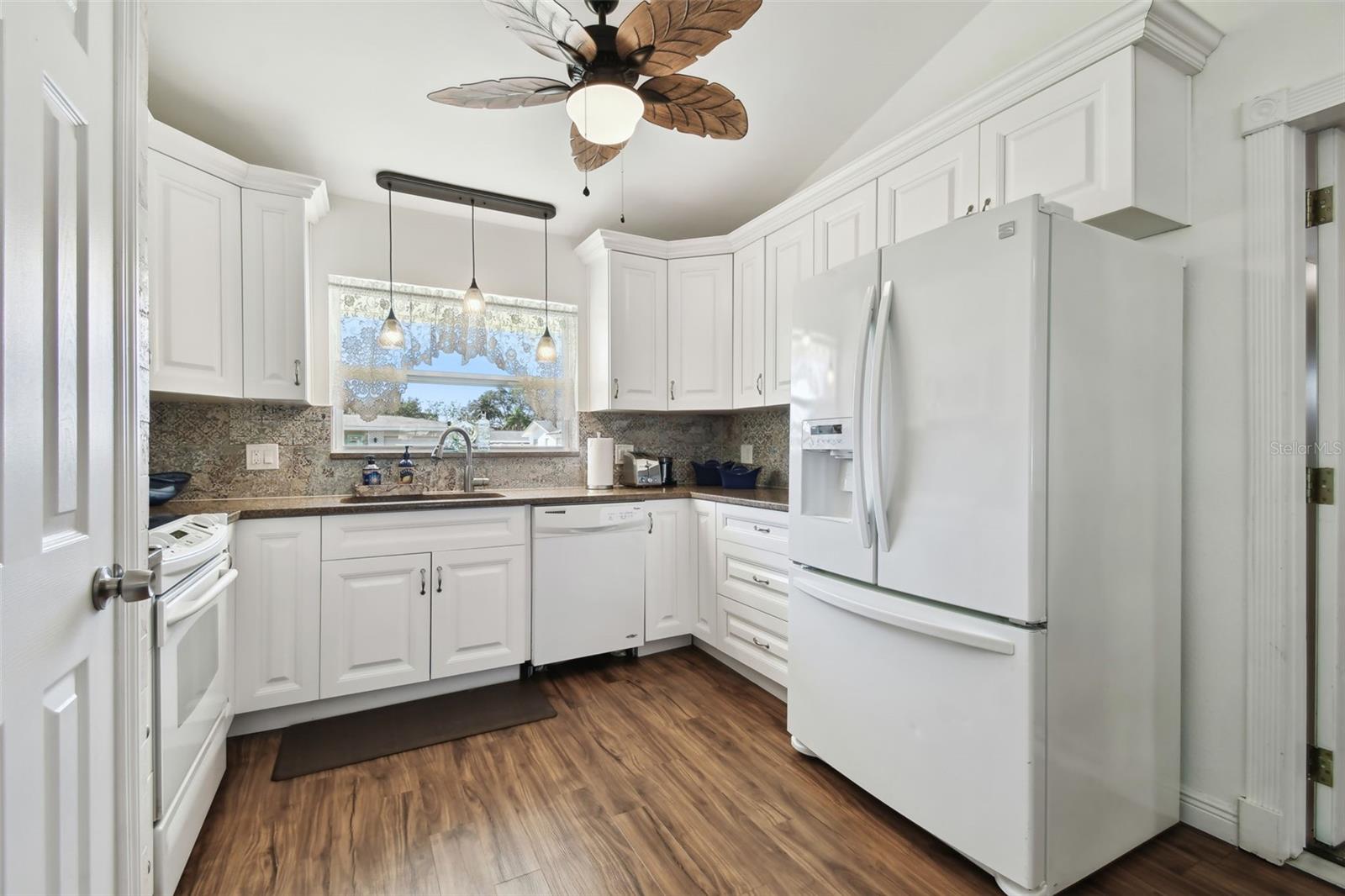 Light-filled kitchen with closet pantry.