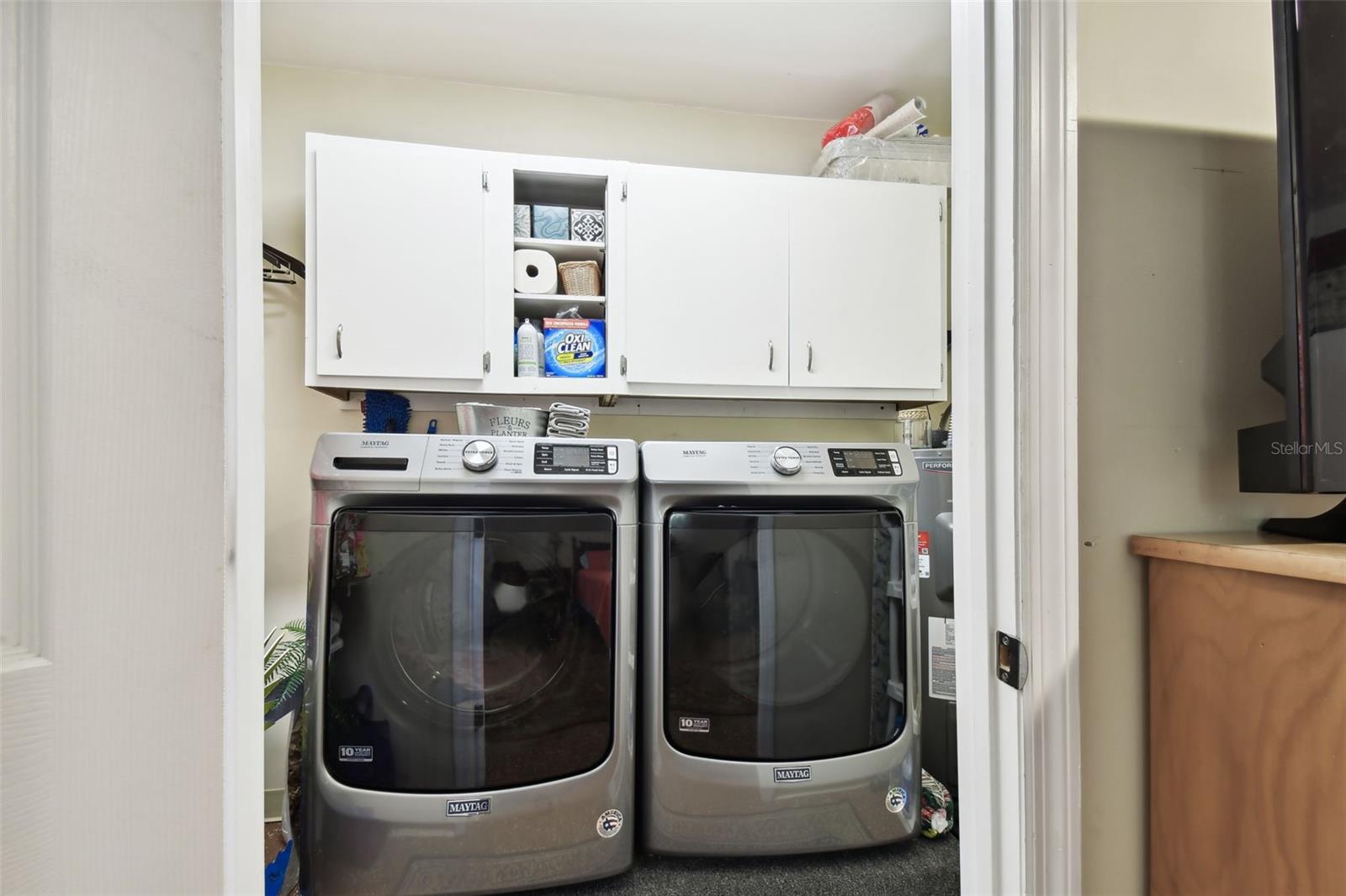 Washer and dryer do not convey. Inside laundry room that is air-conditioned by mini-split in garage conversion. 40-gallon Water heater is in same room to right of washer/dryer.