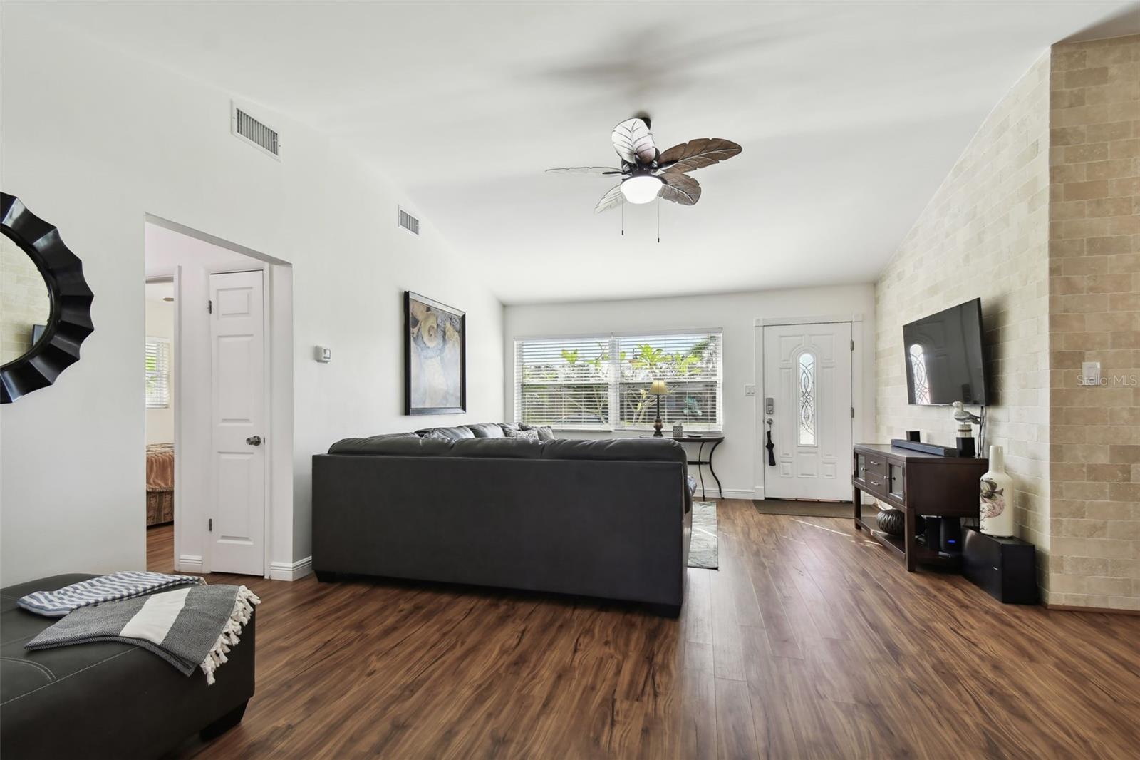 New Luxury Vinyl Floors and brick re-facing on wall.