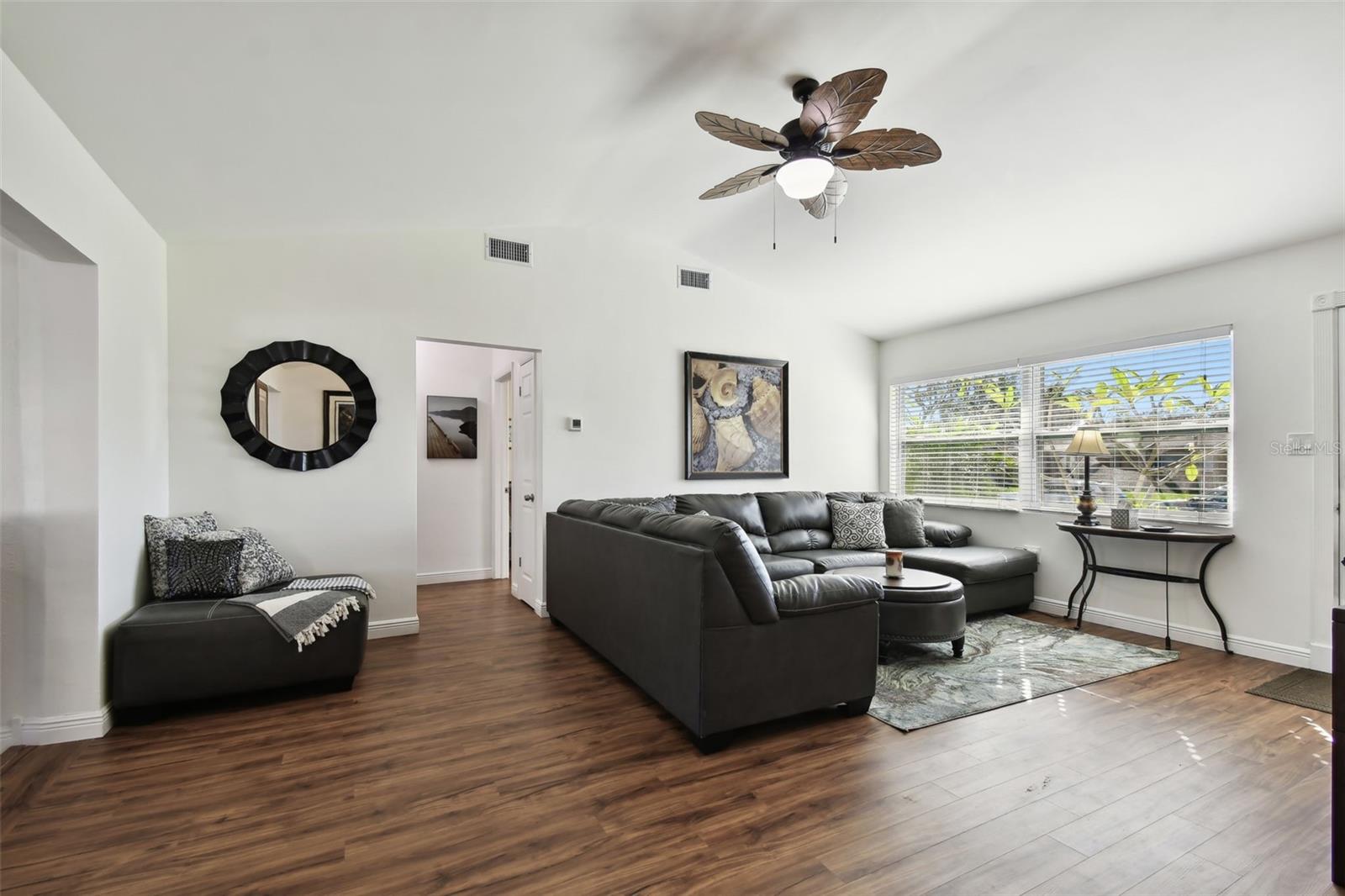 Notice the vaulted ceiling adding a sense of spaciousness to the living and dining area. Across the room, two bedrooms and bath give privacy from the kitchen and dining area.