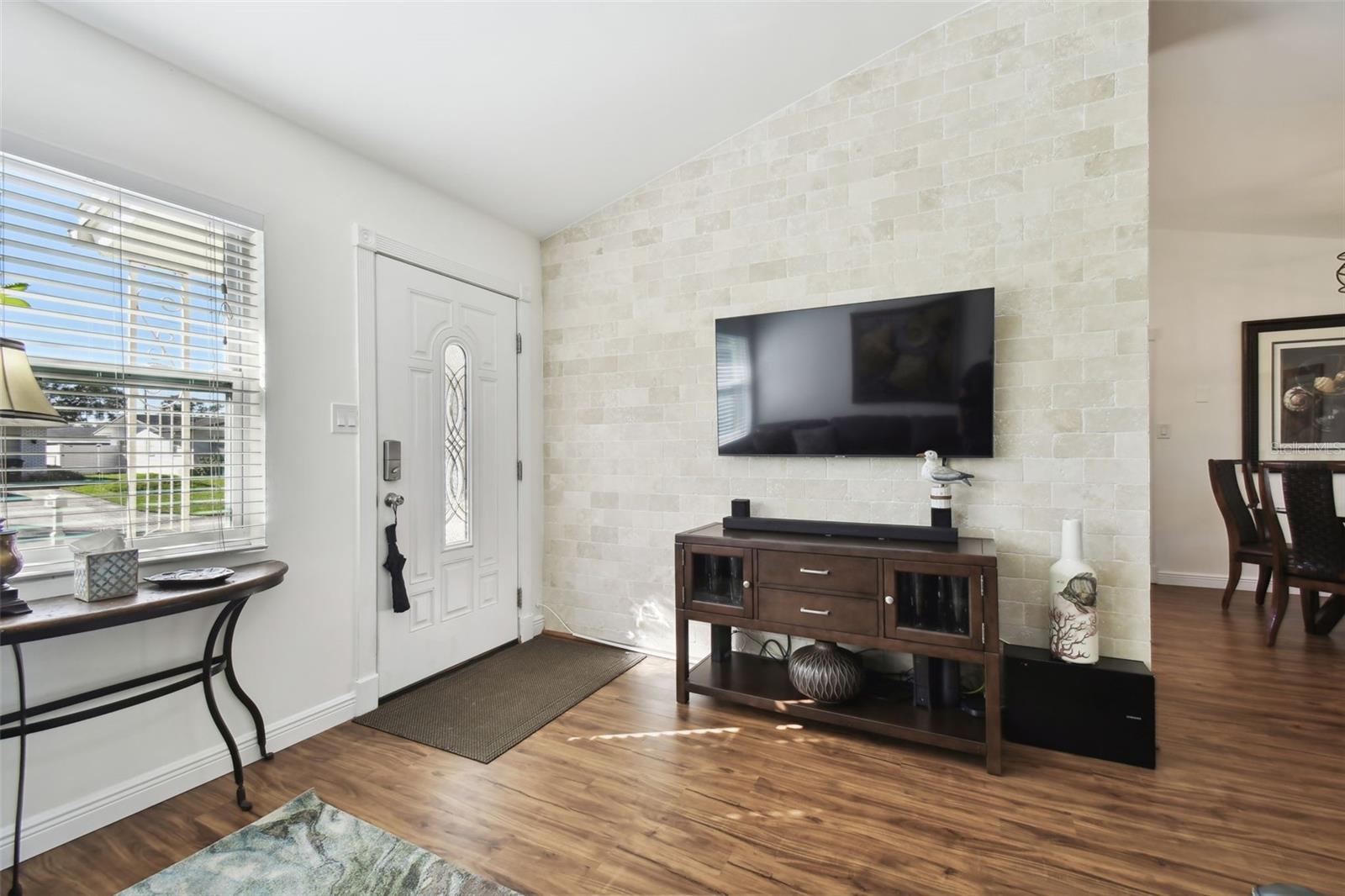 Attractive brick wall adding character to the space. Kitchen is on the other side of brick wall.