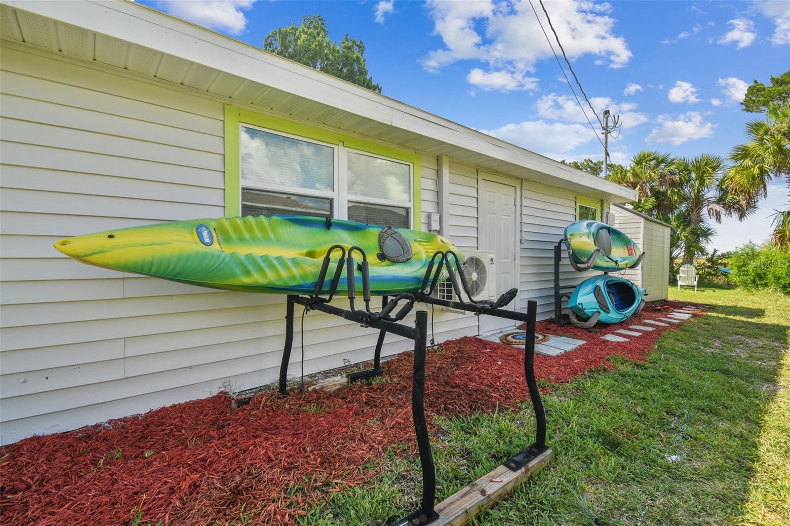 Aug 2024 side of home with kayaks