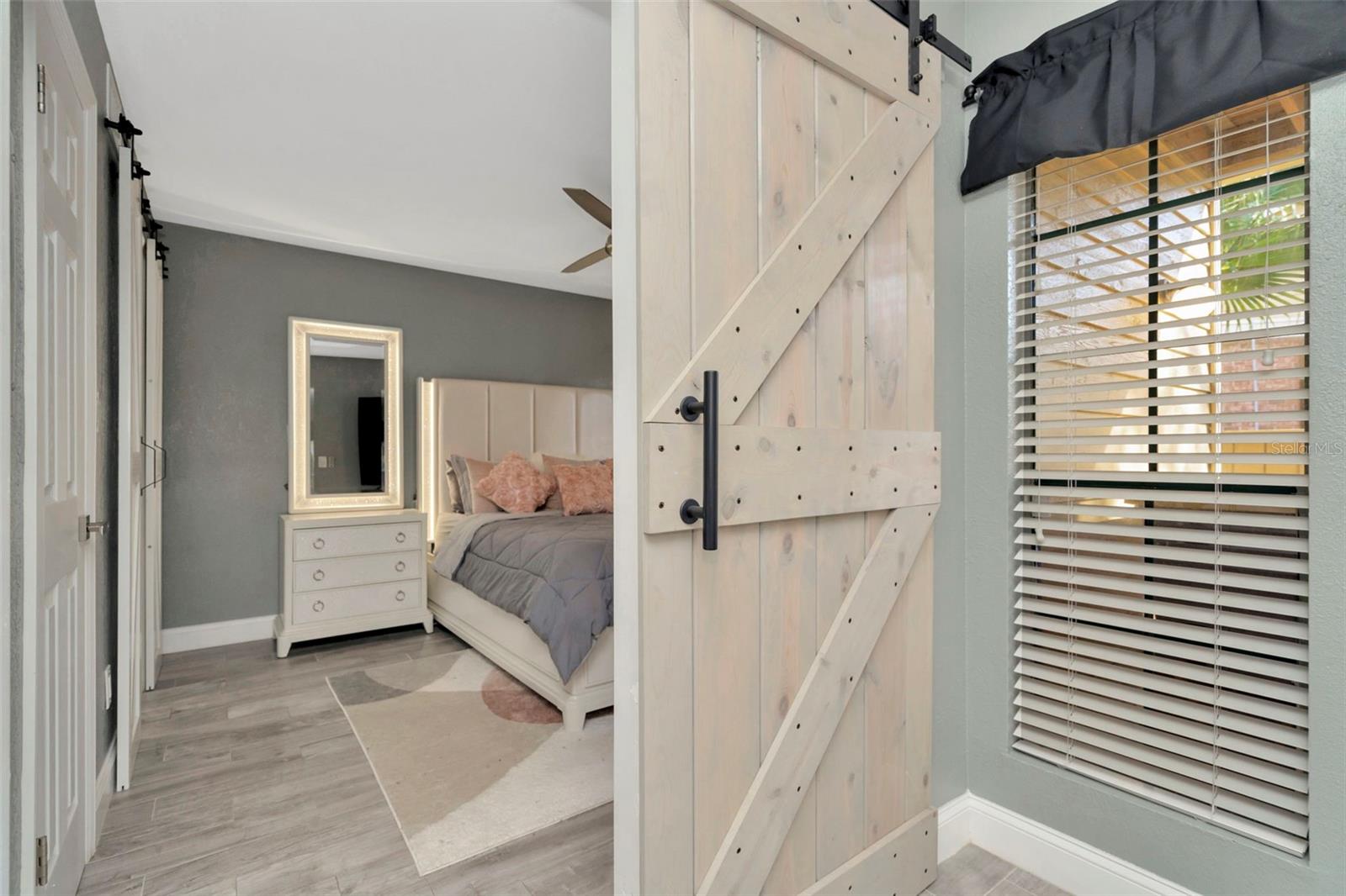 Primary bedroom with barn door entry