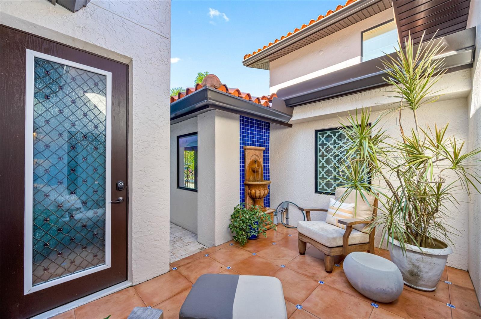 Courtyard with a fountain and access to 4 car garage