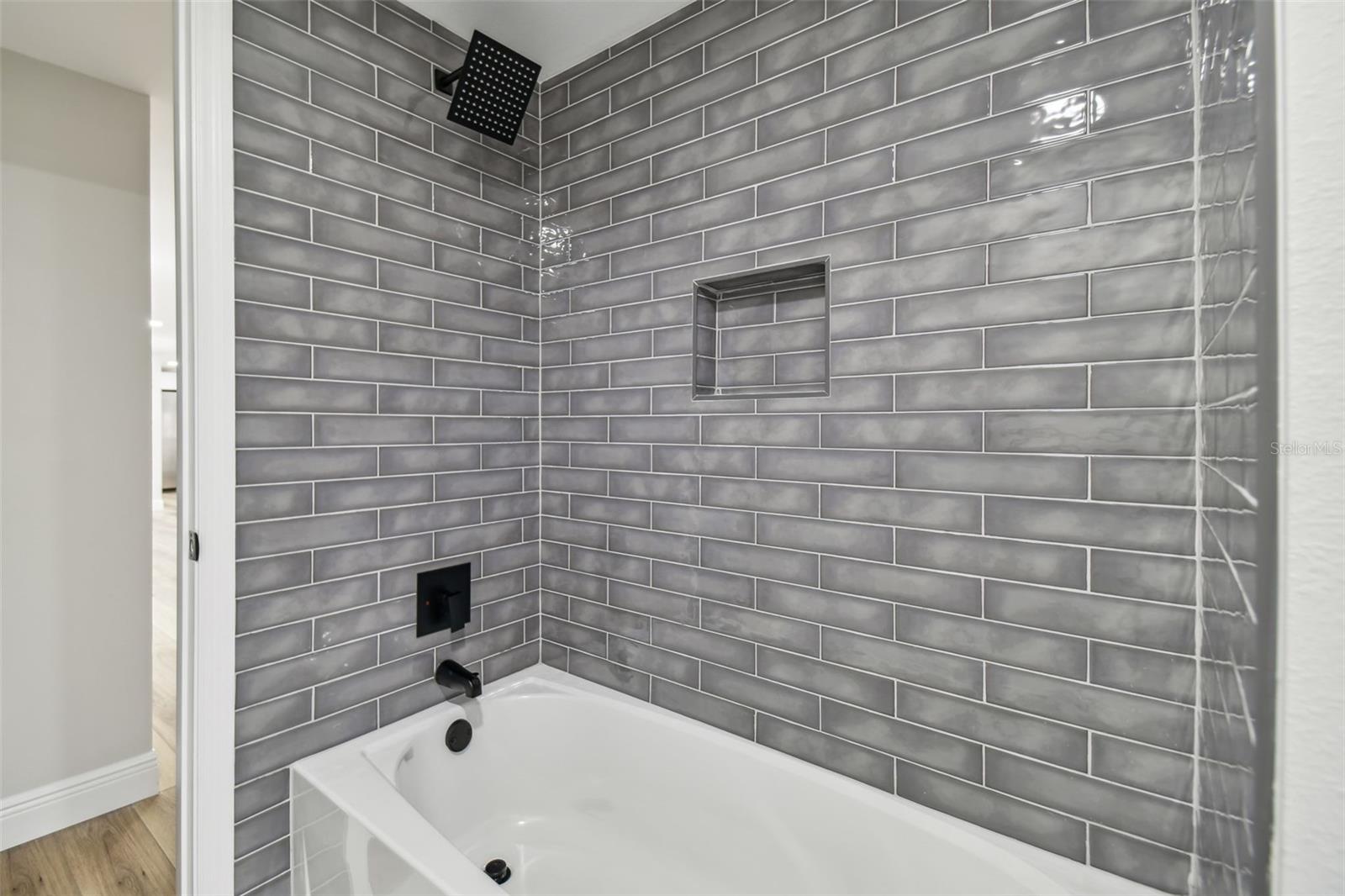 Beautiful tile and custom shampoo niche