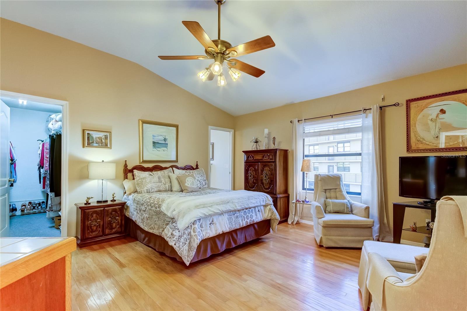 Primary Upstairs Bedroom showing Walk-In Closet to the Left and En-Suite Bathroom Entrance to the Right