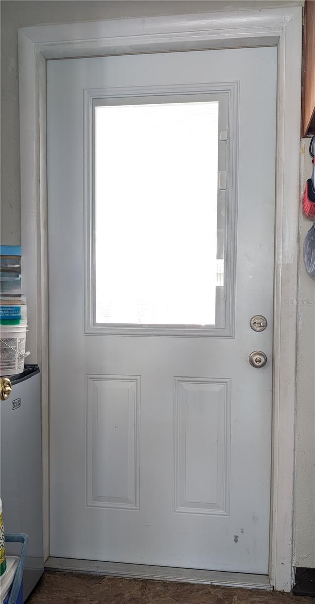 Laundry Room door to Carport with built-in micro blind