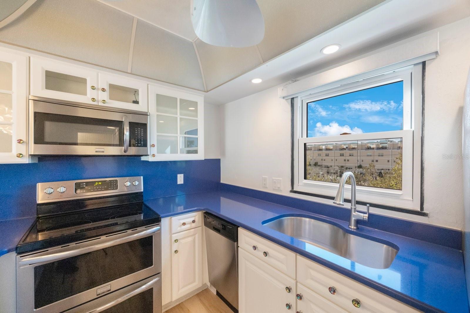 Kitchen window and large sink provide a view for the cook and lots of rinsing space.