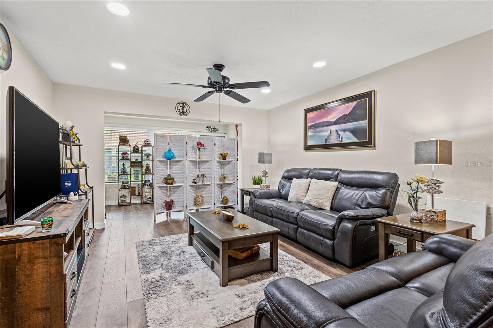 Living room area with a view of the open Florida room.