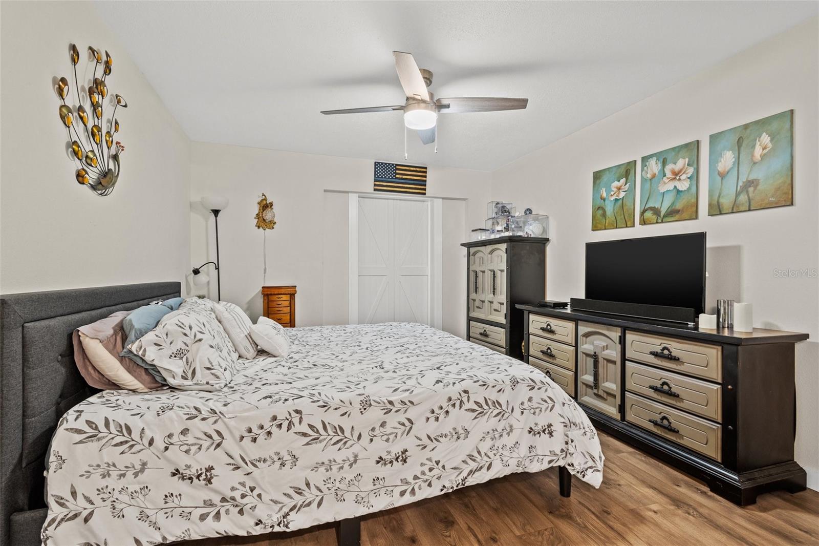 The master bedroom comes with newly installed barn doors that open up to the spacious Florida room.