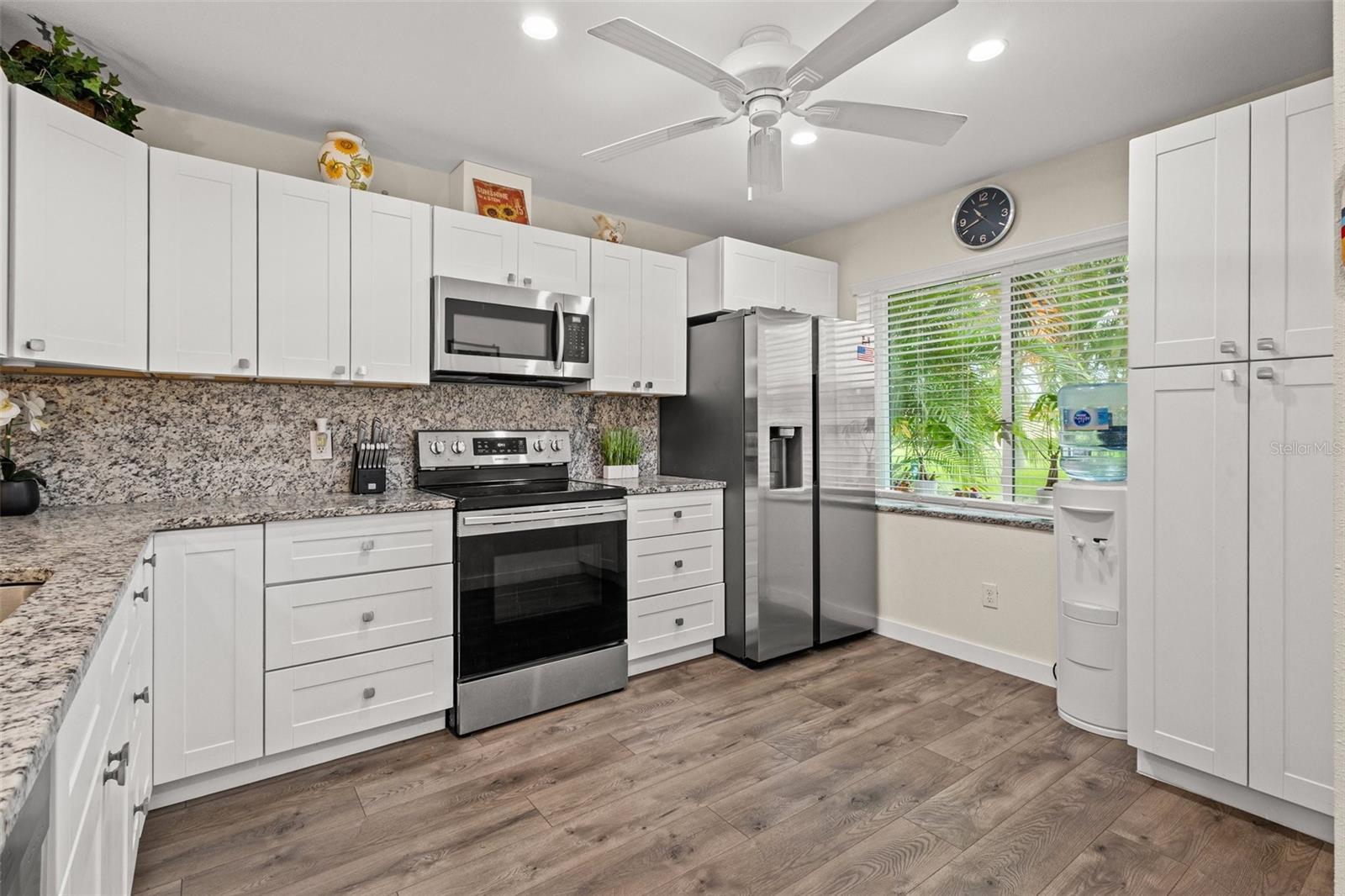 The kitchen comes with a ceiling fan and recessed lighting