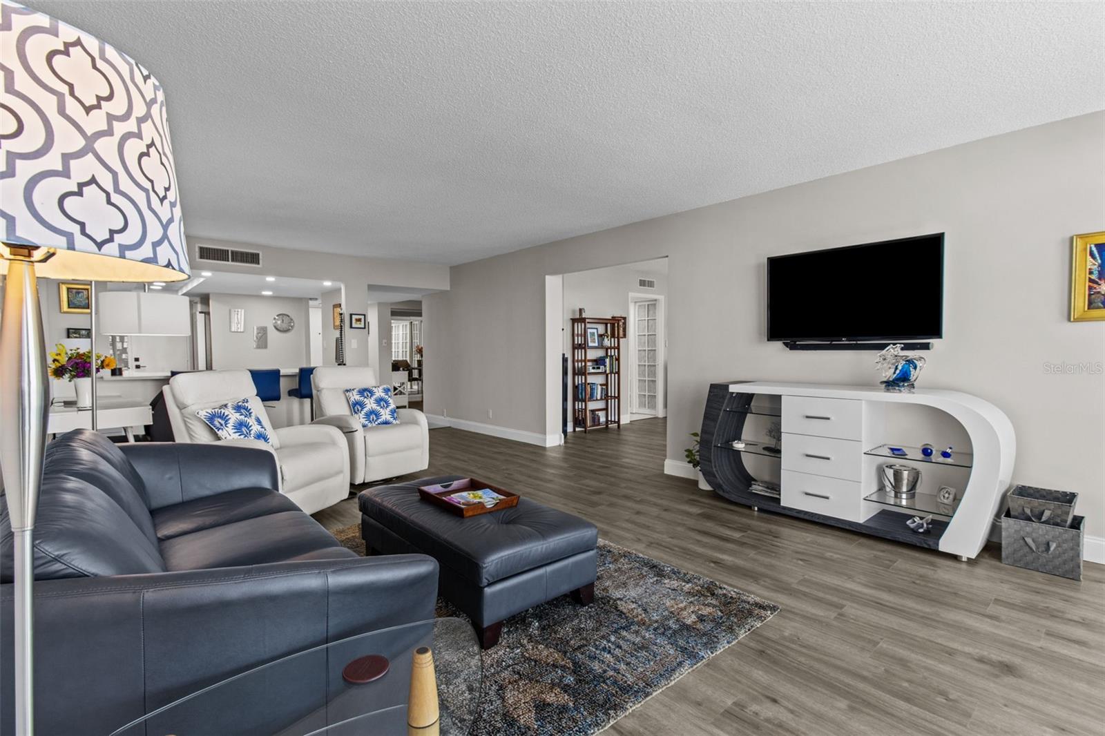 With beautifully coordinated flooring and ample wall space, this open-concept layout is ideal for both relaxing and entertaining.