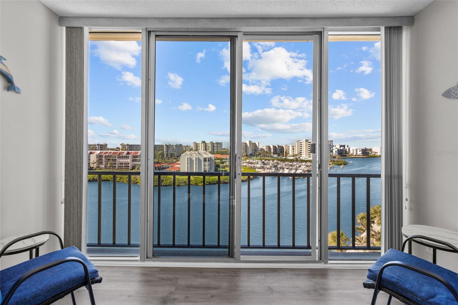 The screened balcony is the perfect spot to unwind and soak in the breathtaking views of the Intracoastal.