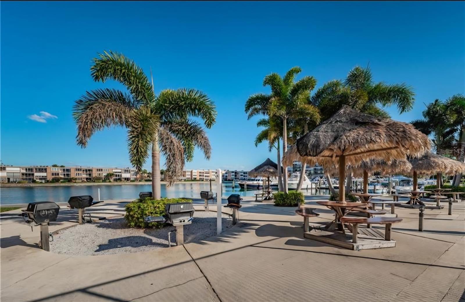 The Sun Island community boasts an array of amenities, including a charming barbecue area perfect for gatherings and relaxation while enjoying the water views.