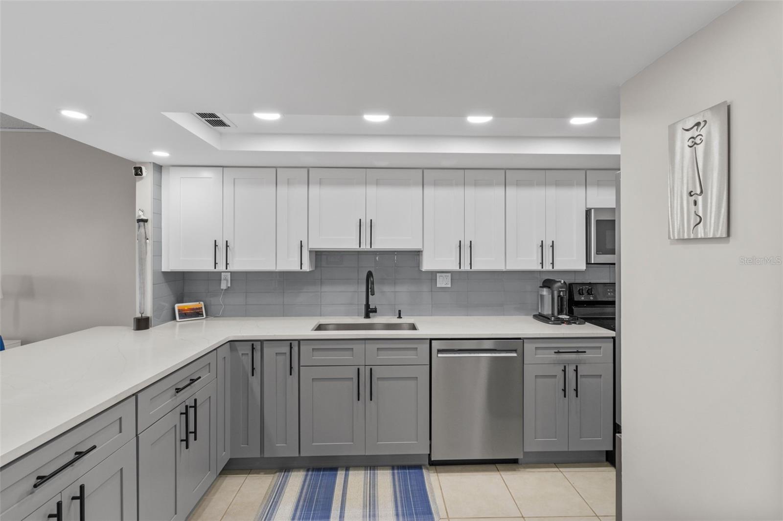 The expansive kitchen features beautifully crafted cabinets in a timeless, neutral color palette.