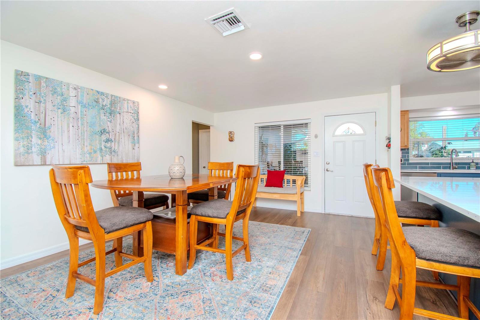 Front Door and dining area with kitchen island