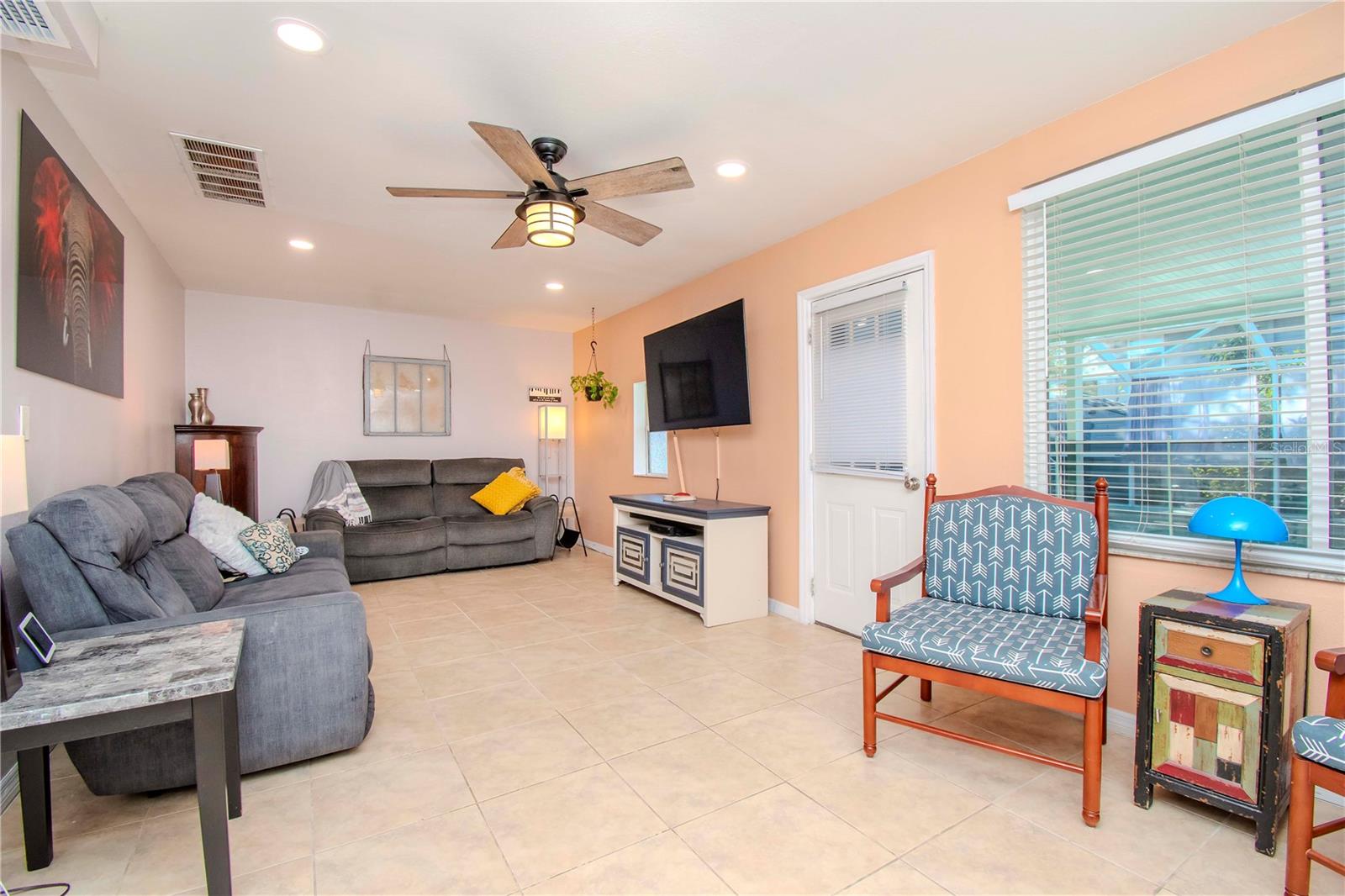 Family room or living room and door outside to the pool.