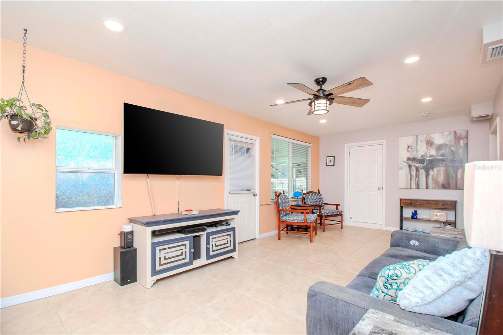 Family room view.  One door leads to the pool area and the 2nd door opens to the primary bathroom.