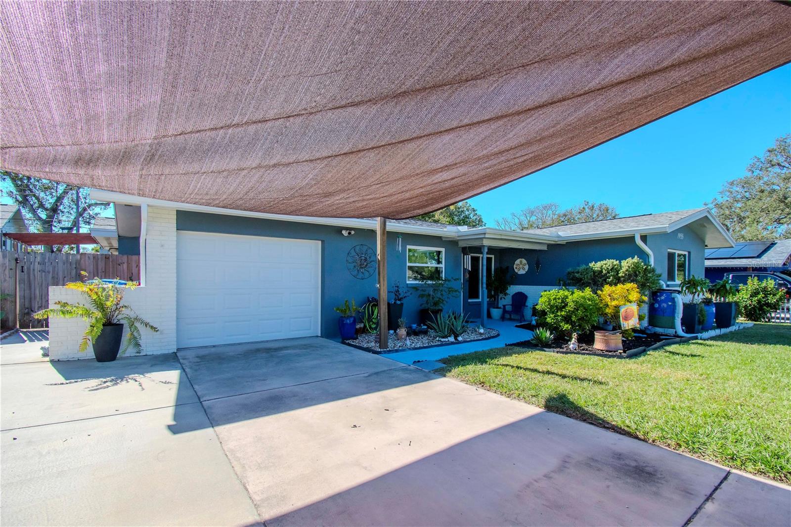 Under the shade parking, garage and side view of home