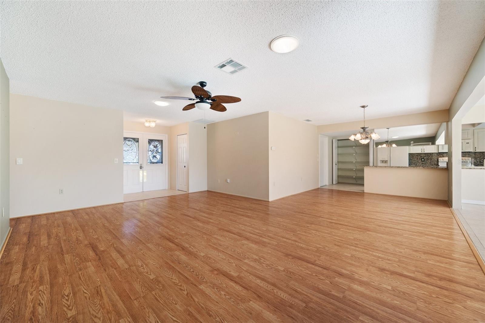 View of living room, front door and dining room