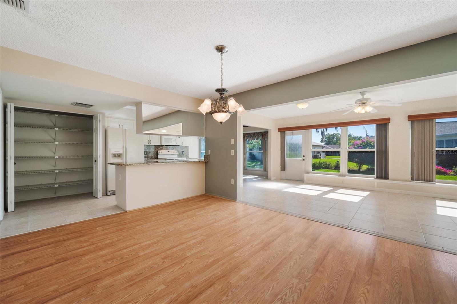 View of kitchen w/large pantry, dining room and family room