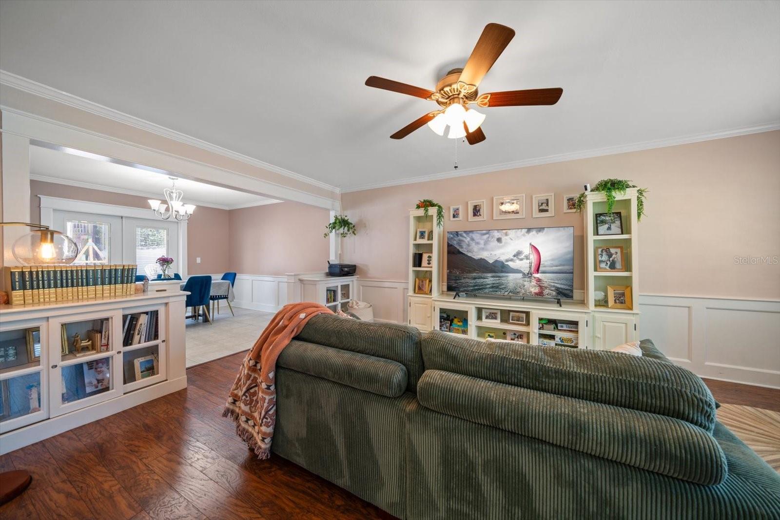 Living room area with attractive built ins, chair railing and crown molding.