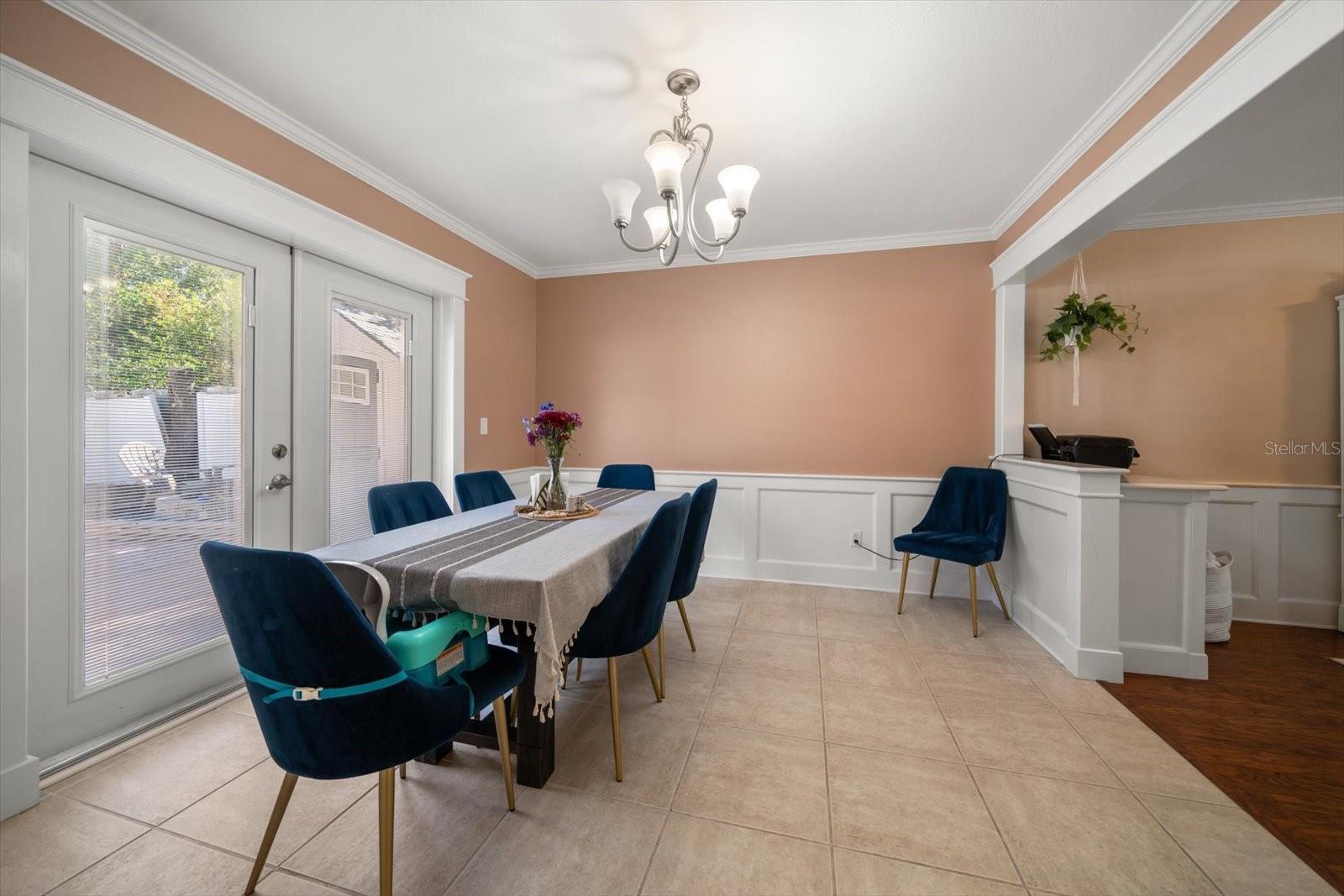 Dining area overlooks large yard and pool.