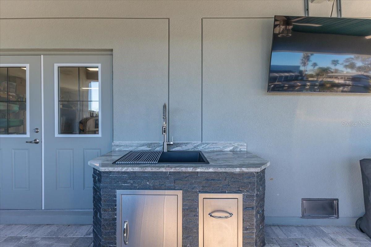 Black Stainless Steel sink with Granite counter, Brick Facade & Moen Brushed Nickel faucet