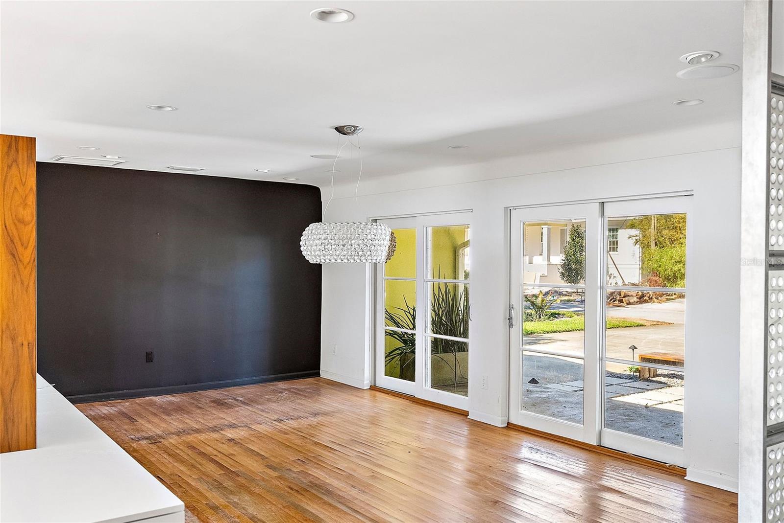 Large dining room with sliders to front patio. Floor must be replaced