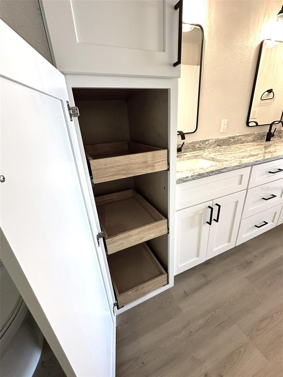 Primary Bath - Linen closet with roll out shelving