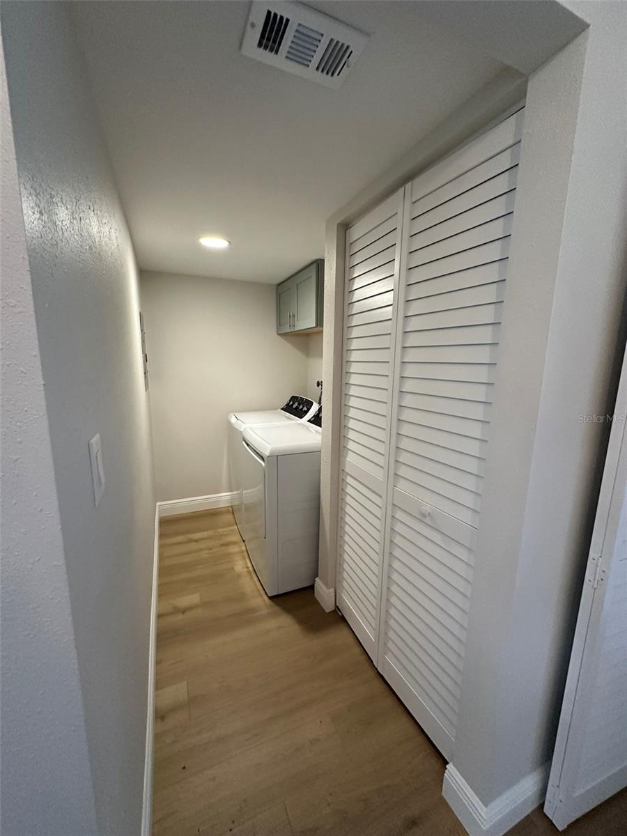 Laundry Room with new full size washer-dryer and storage closet