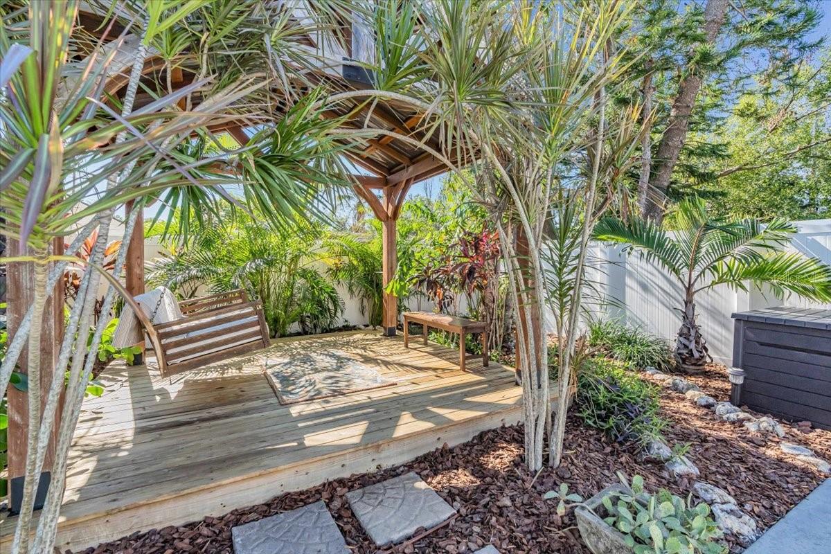 Pressure treated deck with mature palms and enjoyable way to swing the cares away