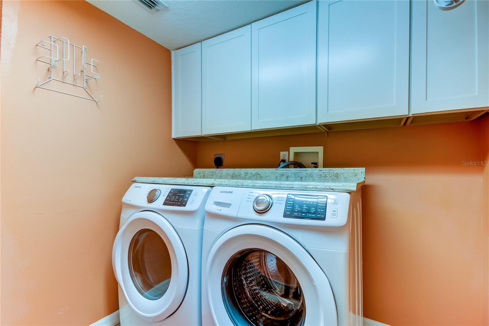 21e. Interior Laundry Room (7' x 9.4') Includes Washer & Dryer.. Granite Look Counter Creates a Perfect Folding Area! Cabinets Overhead for Storage + Rack for Easy Drying of Delicates!