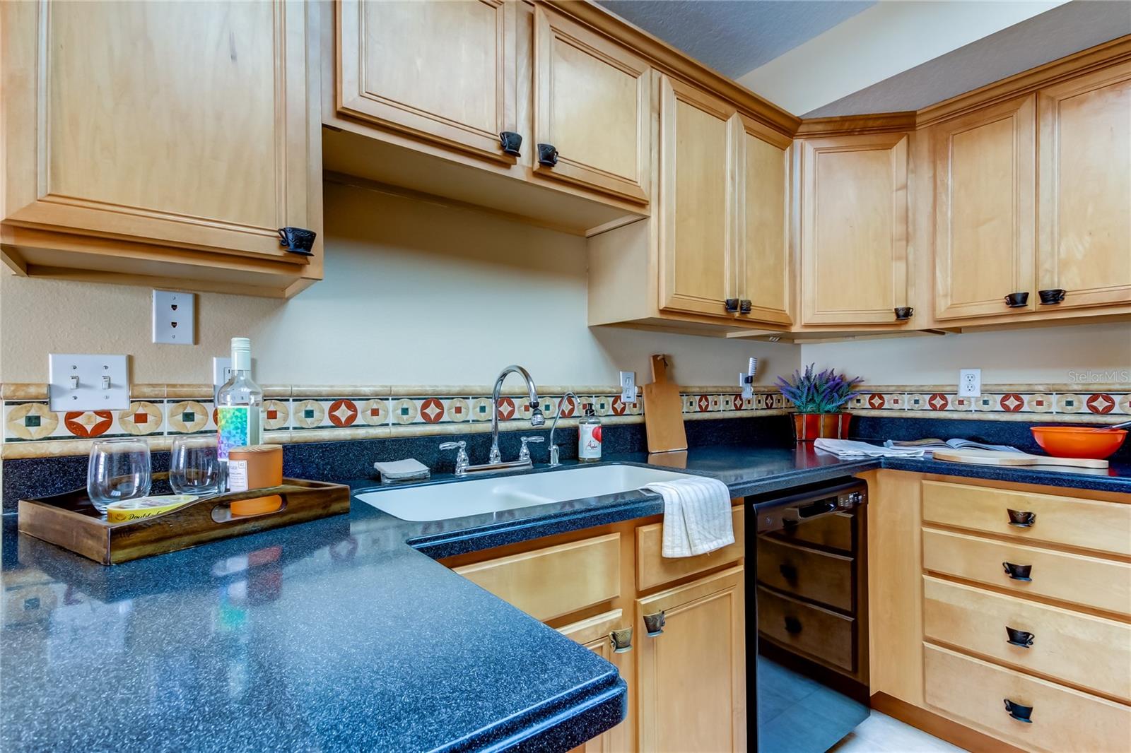 29. Lovely Maple, Solid Wood Cabinets, in an Elevated Shaker Style w/ Extra Panel Detail + Upper Molding.. w Brass Patinated 'Tea Cup' Pulls & Knobs Creates Charm.. & Durable, Everlasting, Black Speckled Corian Counters Makes this Kitchen Timeless!