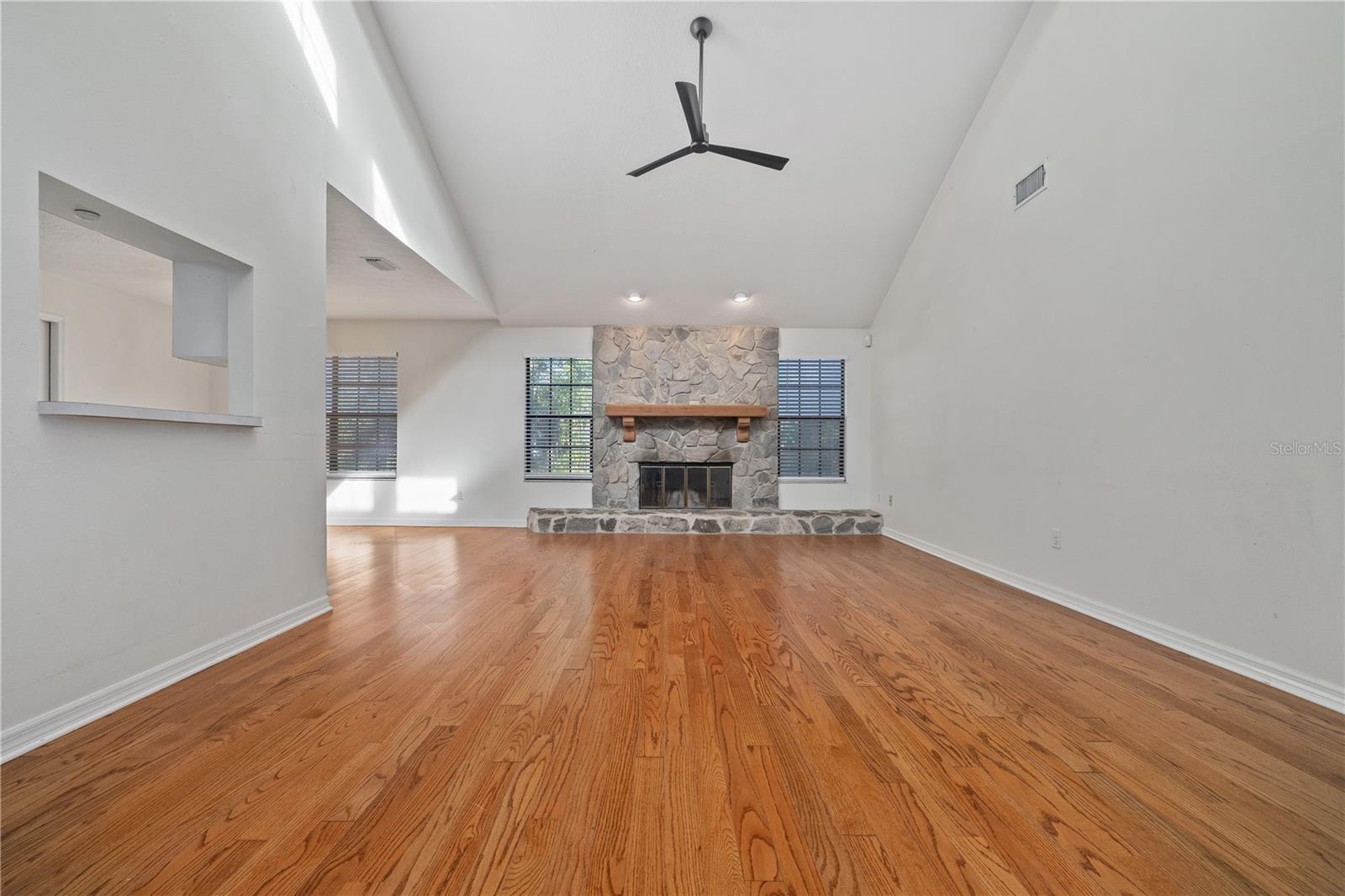 Living Room with high ceilings, stone fireplace