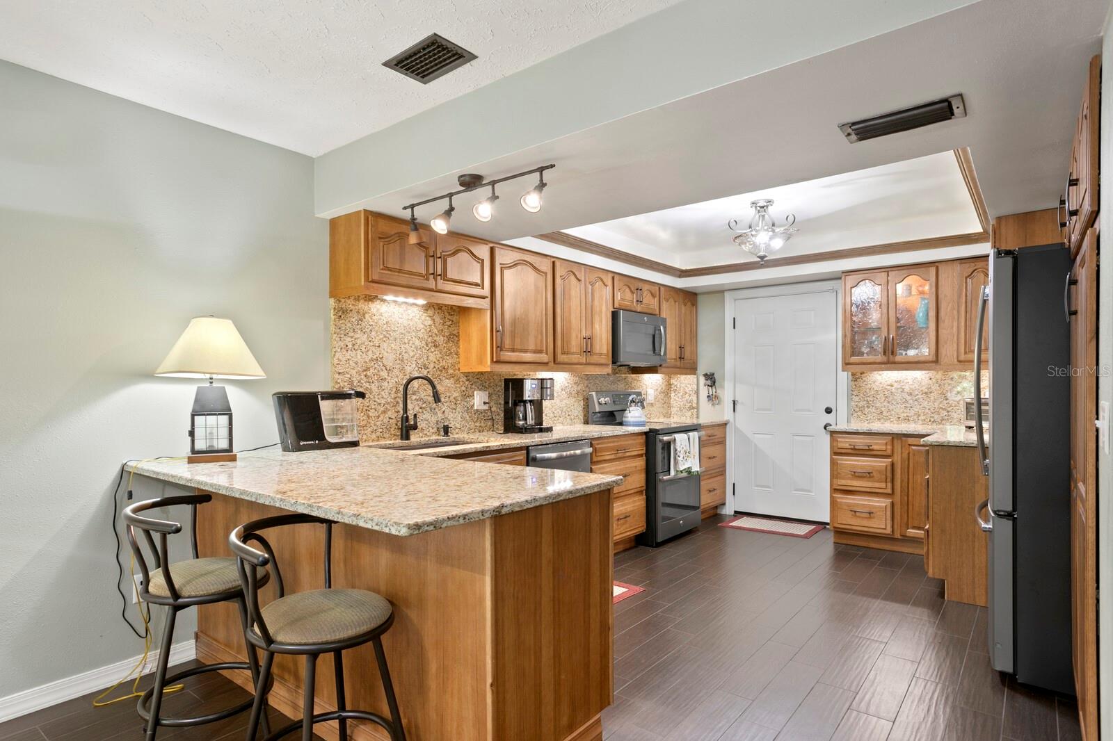 Updated & Enlarged Granite Kitchen With Wood Cabinets