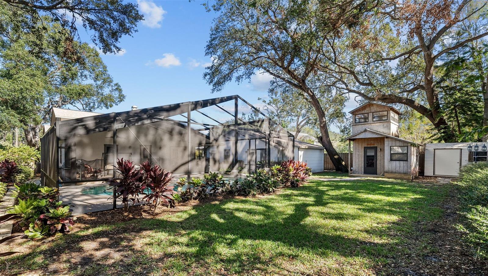 Fully fenced backyard with lush landscaping